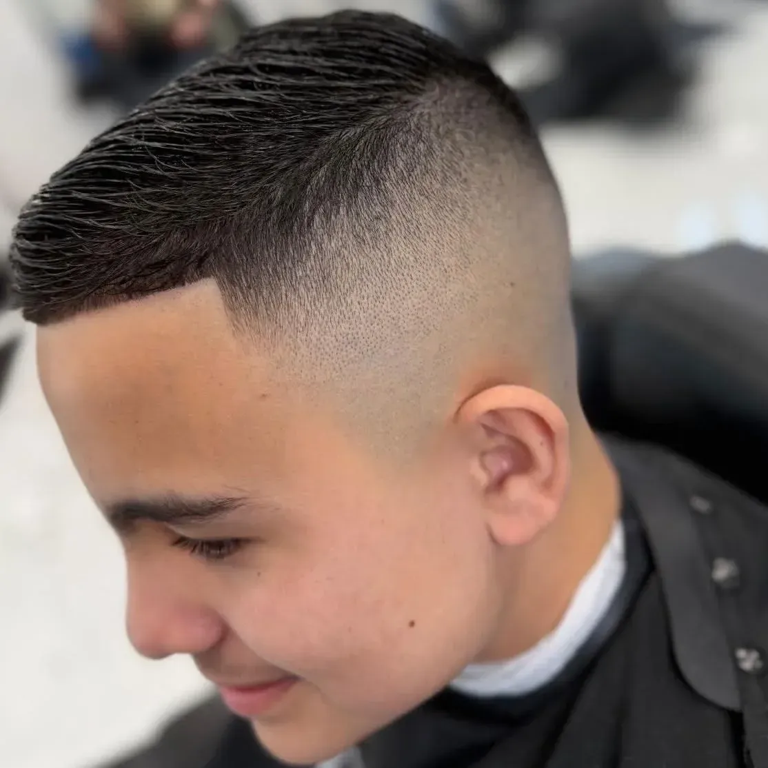 Mid fade haircut at Next Level Barber Shop